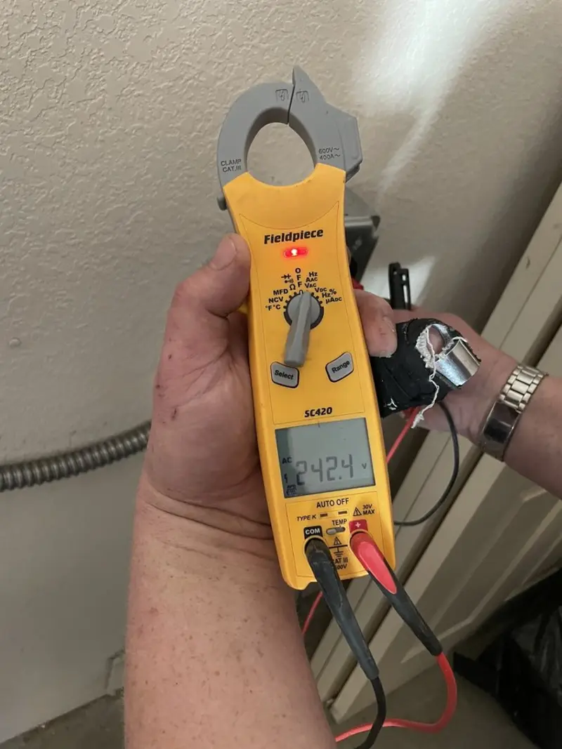 Voltage testing with clamp meter during Recessed Lighting Installation in Englewood